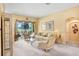 Bright living room featuring neutral walls, plush carpet, and backyard view at 1212 Baycove Ln, Lutz, FL 33549