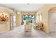 Bright living room featuring neutral walls, plush carpet, and large windows with backyard view at 1212 Baycove Ln, Lutz, FL 33549