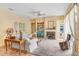 Inviting living room features a fireplace, plush carpeting, and views of the yard at 1212 Baycove Ln, Lutz, FL 33549