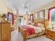 Comfortable main bedroom with ceiling fan, ensuite bathroom, and access to the outdoor pool at 1212 Baycove Ln, Lutz, FL 33549