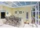 Covered patio featuring an outdoor kitchen and bar seating for entertaining at 1212 Baycove Ln, Lutz, FL 33549