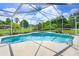 Sparkling pool with screened enclosure, and well manicured lawn and landscaping at 1212 Baycove Ln, Lutz, FL 33549