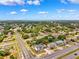 This is an aerial view of a suburban neighborhood showcasing tidy streets, lush greenery, and a variety of single-Gathering homes at 12470 Elgin Blvd, Spring Hill, FL 34609