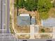 An aerial view of a single-Gathering home with a gray roof and a compact yard near a street intersection at 12470 Elgin Blvd, Spring Hill, FL 34609
