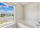 Corner soaking tub with bright light through the window at 12470 Elgin Blvd, Spring Hill, FL 34609