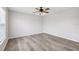 Bedroom with new gray hardwood flooring, ceiling fan and a large window at 12470 Elgin Blvd, Spring Hill, FL 34609