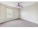 Bedroom with gray carpet, a window with blinds, and a unique purple ceiling fan at 12470 Elgin Blvd, Spring Hill, FL 34609