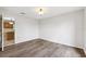 Bedroom with wood floors, a ceiling light, and doorway leading to another room at 12470 Elgin Blvd, Spring Hill, FL 34609