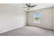 Bright bedroom features a neutral color scheme, plush carpeting, and a sunlit window at 12470 Elgin Blvd, Spring Hill, FL 34609