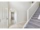 Wide shot of the foyer showing the front door and staircase with a carpeted runner at 12470 Elgin Blvd, Spring Hill, FL 34609