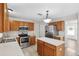 Efficient kitchen design with stainless steel appliances, tile flooring, and a convenient central island at 12470 Elgin Blvd, Spring Hill, FL 34609