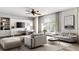Comfortable living room featuring a large window and an adjacent working area with a modern built-in desk at 12470 Elgin Blvd, Spring Hill, FL 34609