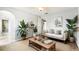 Cozy living room featuring a comfortable sofa, jute rug, and botanical accents for a tranquil feel at 12470 Elgin Blvd, Spring Hill, FL 34609