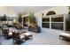 Stylish outdoor patio with a fire pit, lush greenery and comfortable seating, perfect for entertaining at 12470 Elgin Blvd, Spring Hill, FL 34609