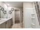 Well-lit bathroom with a double vanity, modern fixtures, and a walk-in shower for a comfortable and functional space at 12842 Canter Call Rd, Lithia, FL 33547