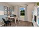 Inviting home office space with natural light, a striped accent wall, and a dedicated bookshelf at 12842 Canter Call Rd, Lithia, FL 33547