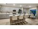 Open-concept kitchen flows into a dining area, featuring an island with seating and stainless appliances at 12842 Canter Call Rd, Lithia, FL 33547