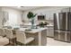 Modern kitchen featuring stainless steel appliances, an island with seating, and gray cabinets at 12842 Canter Call Rd, Lithia, FL 33547
