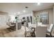 Open concept with view of kitchen, dining room, stainless steel appliances, and white chairs at 12842 Canter Call Rd, Lithia, FL 33547