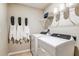 Efficient laundry room with modern washer and dryer units, shelving, and helpful signage for an organized space at 12842 Canter Call Rd, Lithia, FL 33547