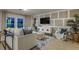 Bright living room featuring modern paneling, sleek furniture, wood floors, and ample natural light at 12842 Canter Call Rd, Lithia, FL 33547