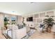 Bright living room featuring modern paneling, sleek furniture, wood floors, and ample natural light at 12842 Call Center Rd, Lithia, FL 33547