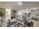 Bright and open-concept living room featuring modern furniture and a seamless flow into the kitchen and dining area at 12842 Canter Call Rd, Lithia, FL 33547