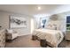 Serene main bedroom with a luxurious bed, elegant decor, and ample natural light creating a restful retreat at 12842 Canter Call Rd, Lithia, FL 33547