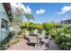Landscaped backyard featuring patio seating, surrounded by lush greenery at 14169 Fennsbury Dr, Tampa, FL 33624