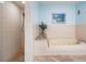 Bathroom showcasing a tub and shower, with tiled walls and granite countertop at 14169 Fennsbury Dr, Tampa, FL 33624