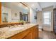 Bathroom featuring double sinks, granite countertop, vanity, a large mirror, and decorative wall accents at 14169 Fennsbury Dr, Tampa, FL 33624