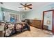 Bright bedroom with tile floors, ceiling fan and access to screened in pool area at 14169 Fennsbury Dr, Tampa, FL 33624