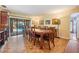 Dining room features table with seating for eight, parquet wood floors and sliding doors with backyard pool view at 14169 Fennsbury Dr, Tampa, FL 33624