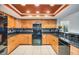 Bright kitchen boasts black appliances, light wood cabinetry, and attractive granite countertops at 14169 Fennsbury Dr, Tampa, FL 33624