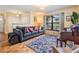 Cozy living room with a comfortable sofa, colorful rug, and natural light streaming through the large window at 14169 Fennsbury Dr, Tampa, FL 33624