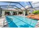 Enclosed pool area features a pool, water feature, outdoor seating, and landscaped perimeter at 14169 Fennsbury Dr, Tampa, FL 33624