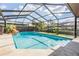 Enclosed pool area features a pool, water feature, outdoor seating, and landscaped perimeter at 14169 Fennsbury Dr, Tampa, FL 33624