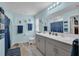 Bright bathroom with a double sink vanity, decorative towels and a blue shower curtain at 14643 Brumby Ridge Ave, Lithia, FL 33547