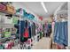 Walk in closet with wire shelving, lots of clothes, shoes and bins of accessories at 14643 Brumby Ridge Ave, Lithia, FL 33547