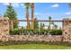 Elegant stone entrance to Hawkstone community, featuring lush landscaping and a welcoming ambiance at 14643 Brumby Ridge Ave, Lithia, FL 33547