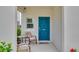 Welcoming front porch with seating, a bright blue door, and decorative accents for a cozy entry at 14643 Brumby Ridge Ave, Lithia, FL 33547