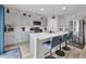 Contemporary kitchen with a large island, stylish barstools, stainless steel appliances, and grey cabinetry at 14643 Brumby Ridge Ave, Lithia, FL 33547