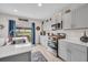 Kitchen with gray cabinets, stainless steel appliances, island, and backyard view at 14643 Brumby Ridge Ave, Lithia, FL 33547