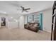 Relaxing upstairs living area with a comfortable couch and ceiling fan at 14643 Brumby Ridge Ave, Lithia, FL 33547