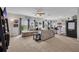 Spacious living room open to kitchen featuring neutral decor, a ceiling fan, and plenty of natural light at 14643 Brumby Ridge Ave, Lithia, FL 33547