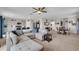 Open concept living space with modern furnishings, ceiling fan, and seamless flow into the dining and kitchen areas at 14643 Brumby Ridge Ave, Lithia, FL 33547