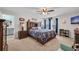 Spacious main bedroom featuring a large bed, dark wood furniture, and ensuite bathroom at 14643 Brumby Ridge Ave, Lithia, FL 33547