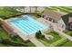 Aerial view of a community pool with a recreation area, swimming lanes, and lush landscaping at 14643 Brumby Ridge Ave, Lithia, FL 33547
