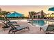 Resort-style pool area with lounge chairs, umbrellas, and a clubhouse, perfect for leisure and recreation at 14643 Brumby Ridge Ave, Lithia, FL 33547