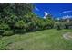 The expansive backyard features lush landscaping, offering privacy and a serene outdoor setting at 1516 E Lake Woodlands Pkwy, Oldsmar, FL 34677